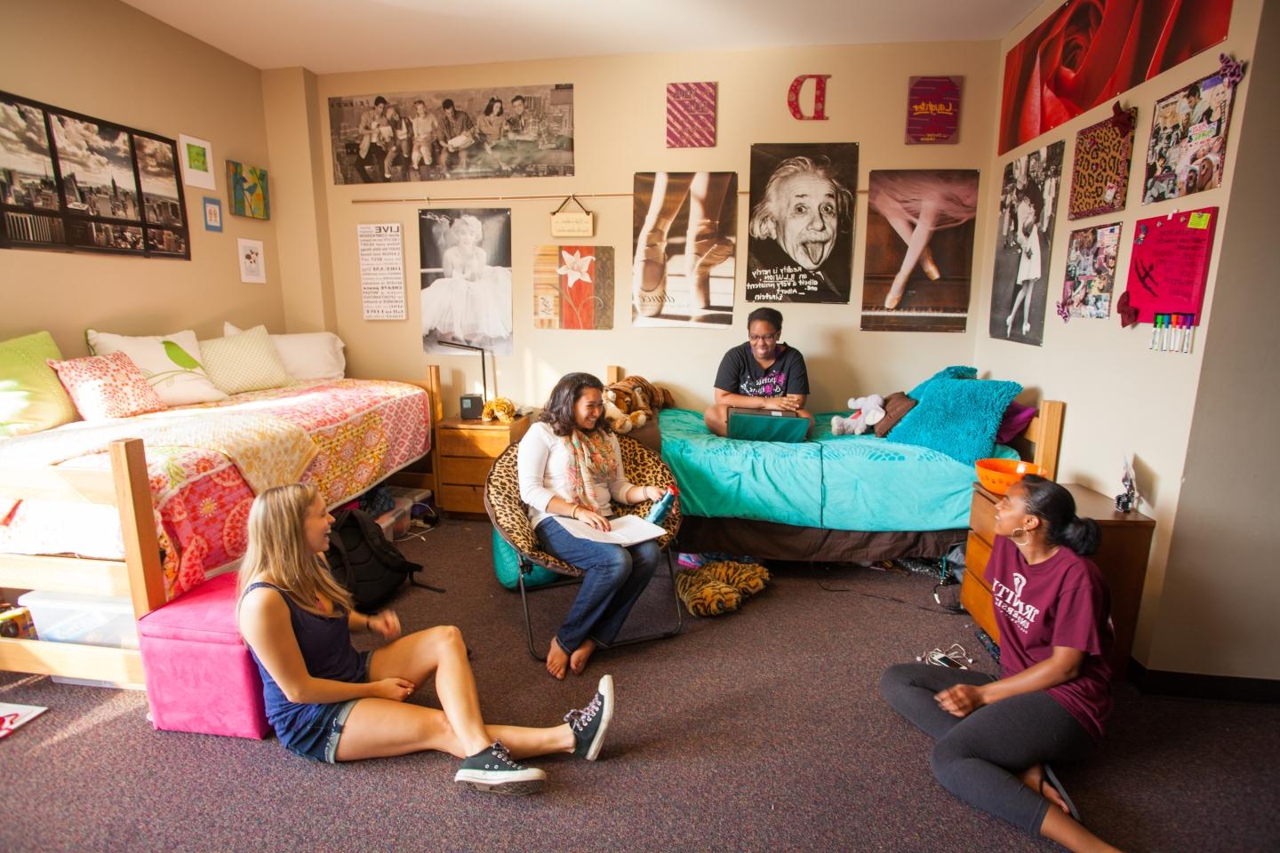 four women sit inside a Prassel Hall dorm room