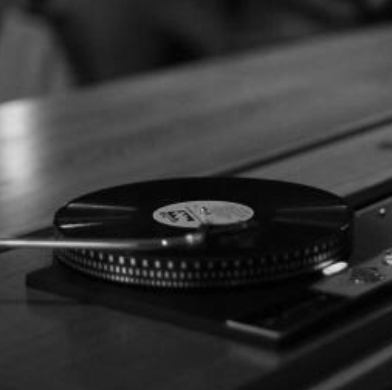Black and white photo of a vinyl record on a turntable