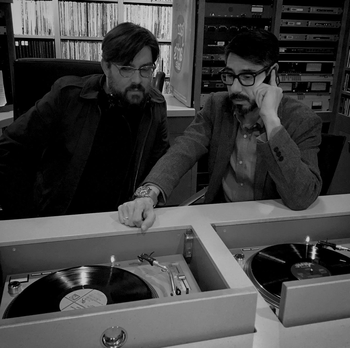 科里·库克和JJ·洛佩兹在录音室里听唱片的黑白照片